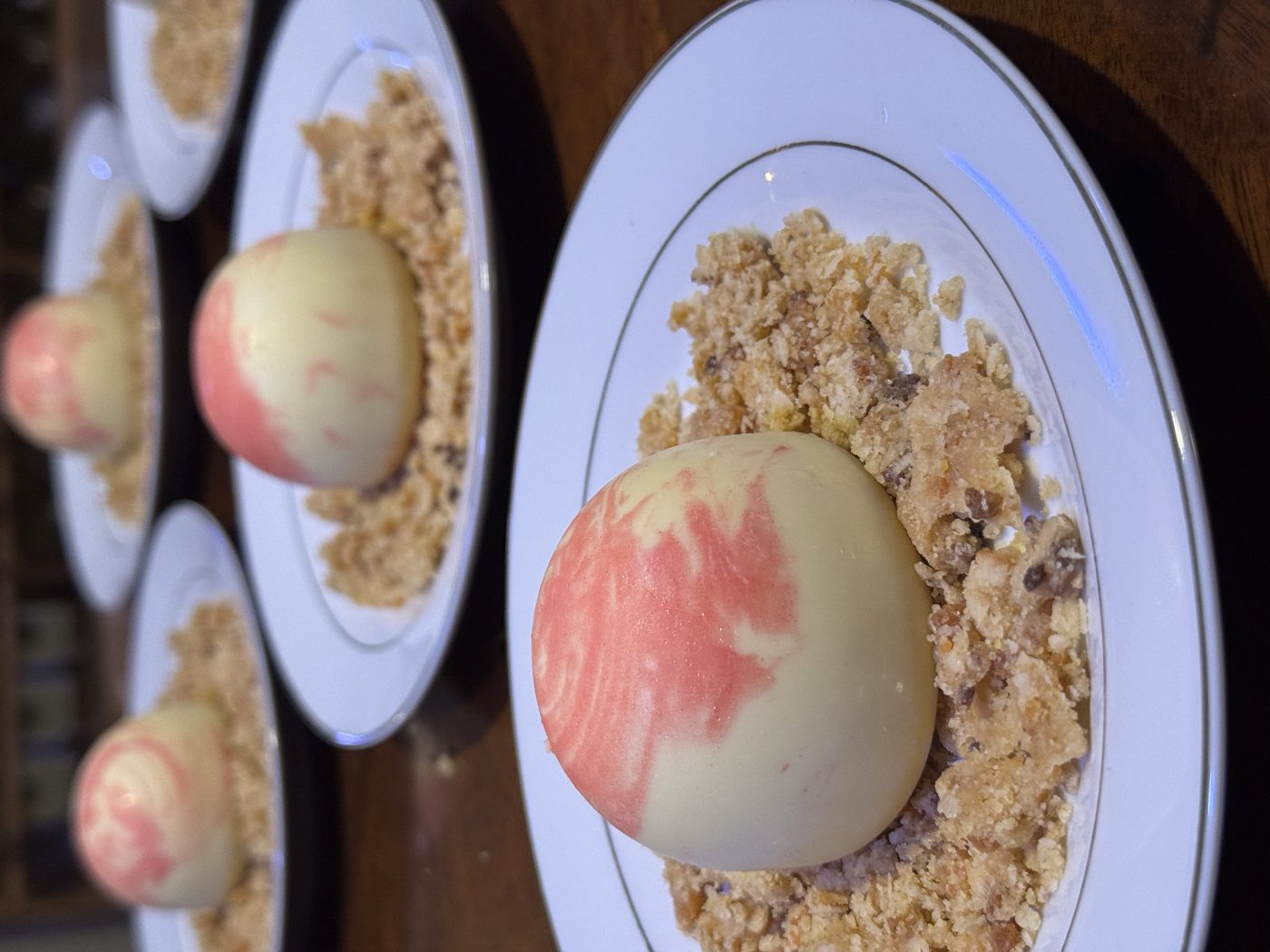 Vanilla bean panna cotta with berry swirl and almond crumble